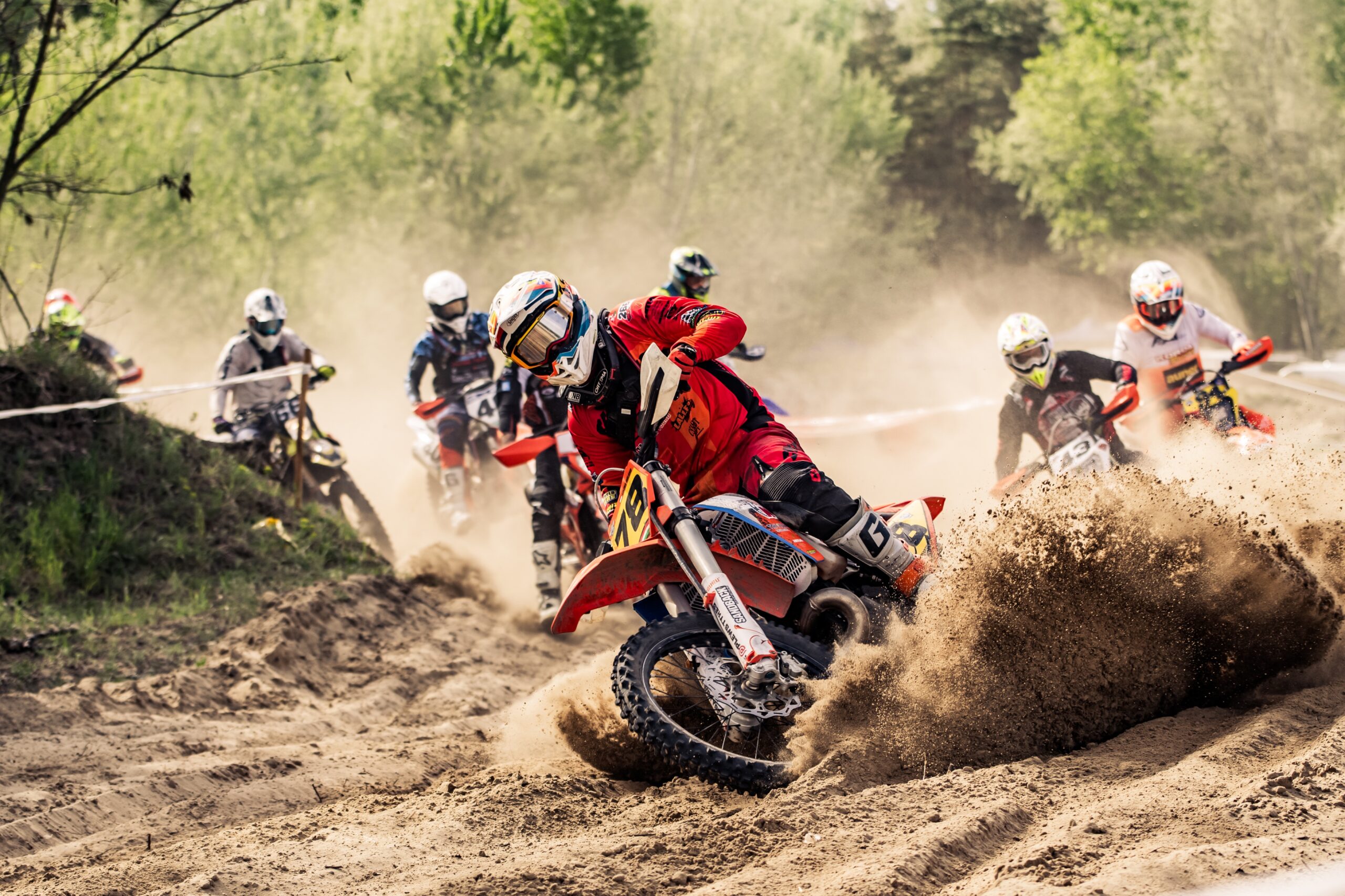 Rider jumping over logs in Endurocross